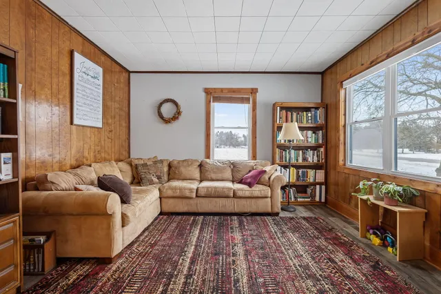 a living room with furniture and a floor to ceiling window