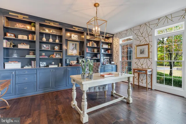 a dining room with furniture a chandelier and wooden floor