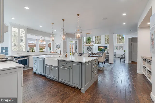 a living room with furniture a flat screen tv and a large window