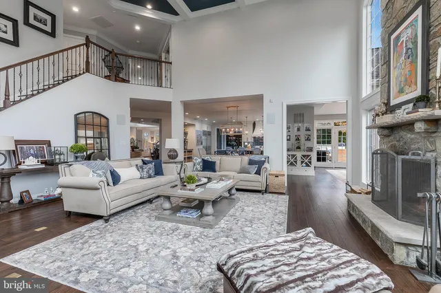 a view of a hallway with windows and chandelier