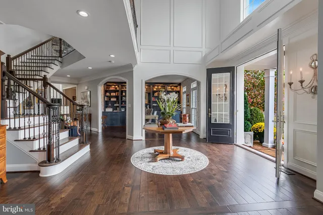 a living room with wooden floor and a table
