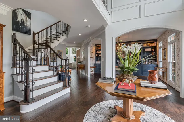 a living room with fireplace furniture and a wooden floor
