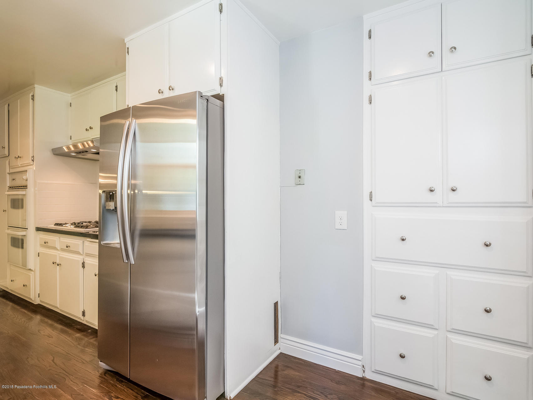 3564 Thorndale Road Pasadena, CA 91107 - Photo 11 of 24 a kitchen with a refrigerator and white cabinets