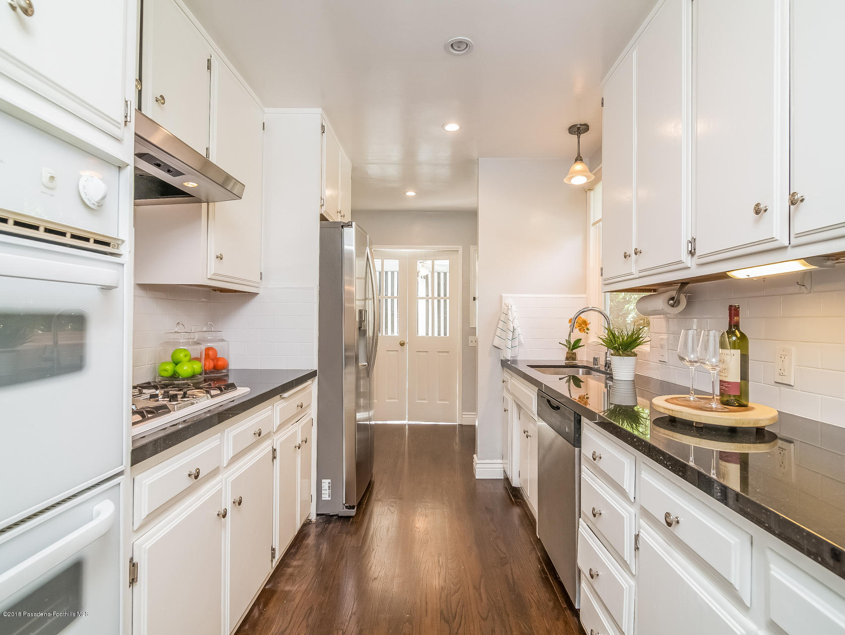 3564 Thorndale Road Pasadena, CA 91107 - Photo 10 of 24 a kitchen with stainless steel appliances granite countertop a lot of counter space and wooden floors