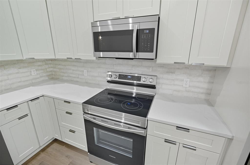 13 Fanshawe Lane Palm Coast, FL 32137 - Photo 17 of 60 a kitchen with granite countertop white cabinets and stainless steel appliances