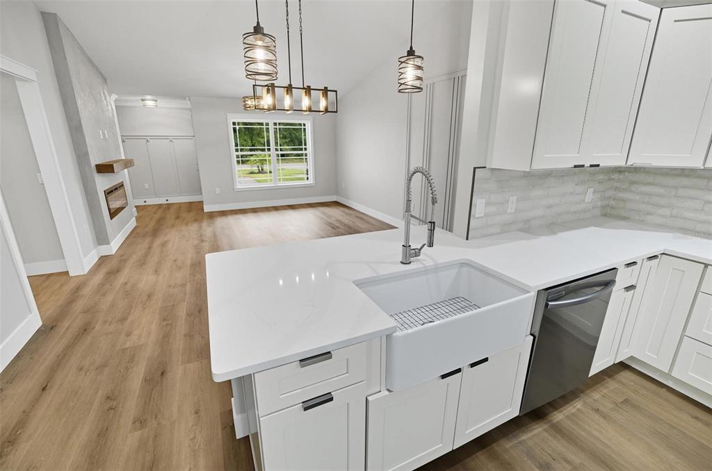 13 Fanshawe Lane Palm Coast, FL 32137 - Photo 18 of 60 a kitchen with a sink a window a wooden floor and stainless steel appliances