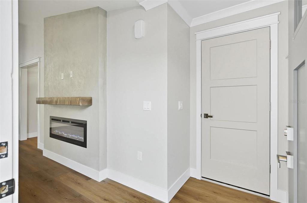 13 Fanshawe Lane Palm Coast, FL 32137 - Photo 2 of 60 a room with wooden floor and a fireplace