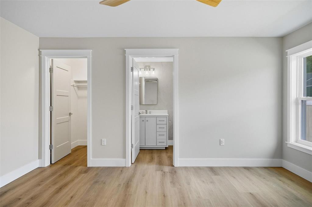 13 Fanshawe Lane Palm Coast, FL 32137 - Photo 24 of 60 an empty room with wooden floor and windows