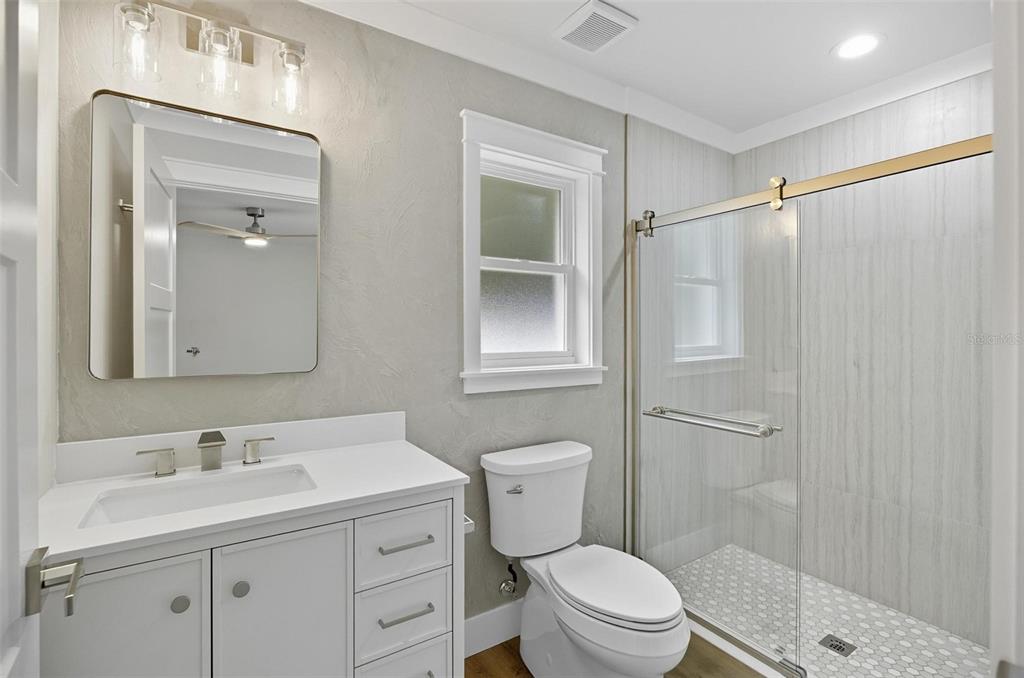 13 Fanshawe Lane Palm Coast, FL 32137 - Photo 25 of 60 a bathroom with a sink a toilet and shower