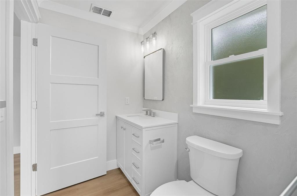 13 Fanshawe Lane Palm Coast, FL 32137 - Photo 26 of 60 a bathroom with a toilet sink and mirror