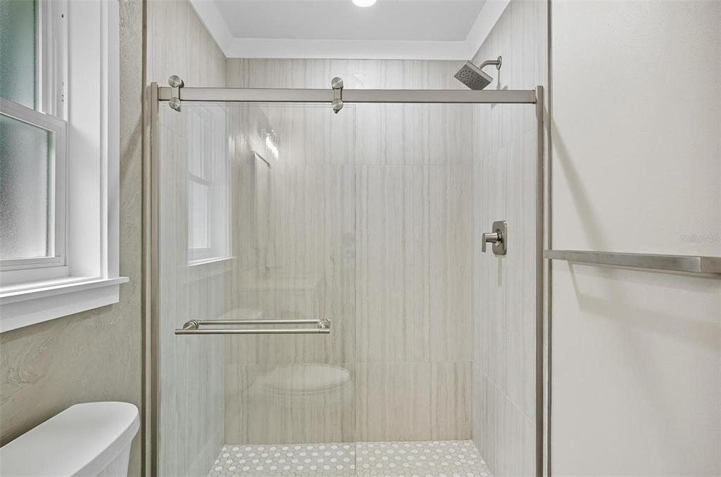 13 Fanshawe Lane Palm Coast, FL 32137 - Photo 27 of 60 a bathroom with a shower and a toilet