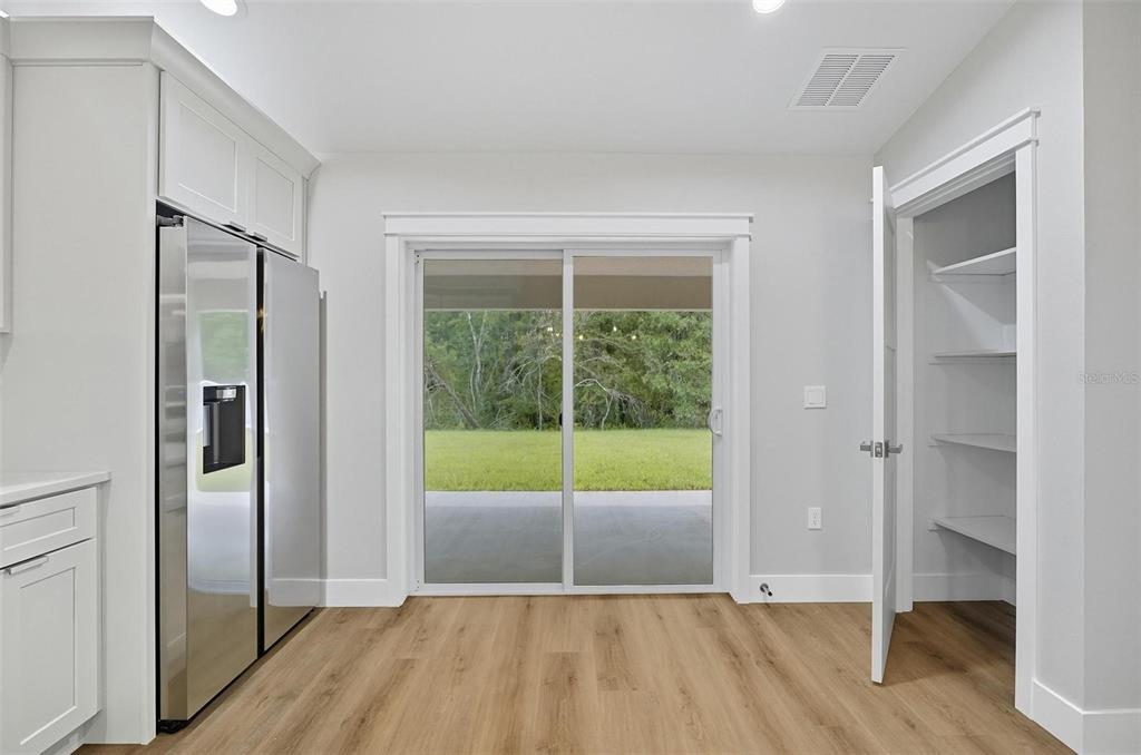 13 Fanshawe Lane Palm Coast, FL 32137 - Photo 28 of 60 a view of empty room with wooden floor and fan
