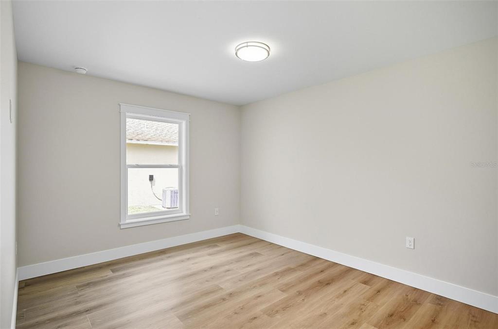 13 Fanshawe Lane Palm Coast, FL 32137 - Photo 30 of 60 an empty room with wooden floor and windows