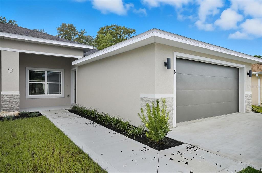 13 Fanshawe Lane Palm Coast, FL 32137 - Photo 38 of 60 a front view of a house with a yard