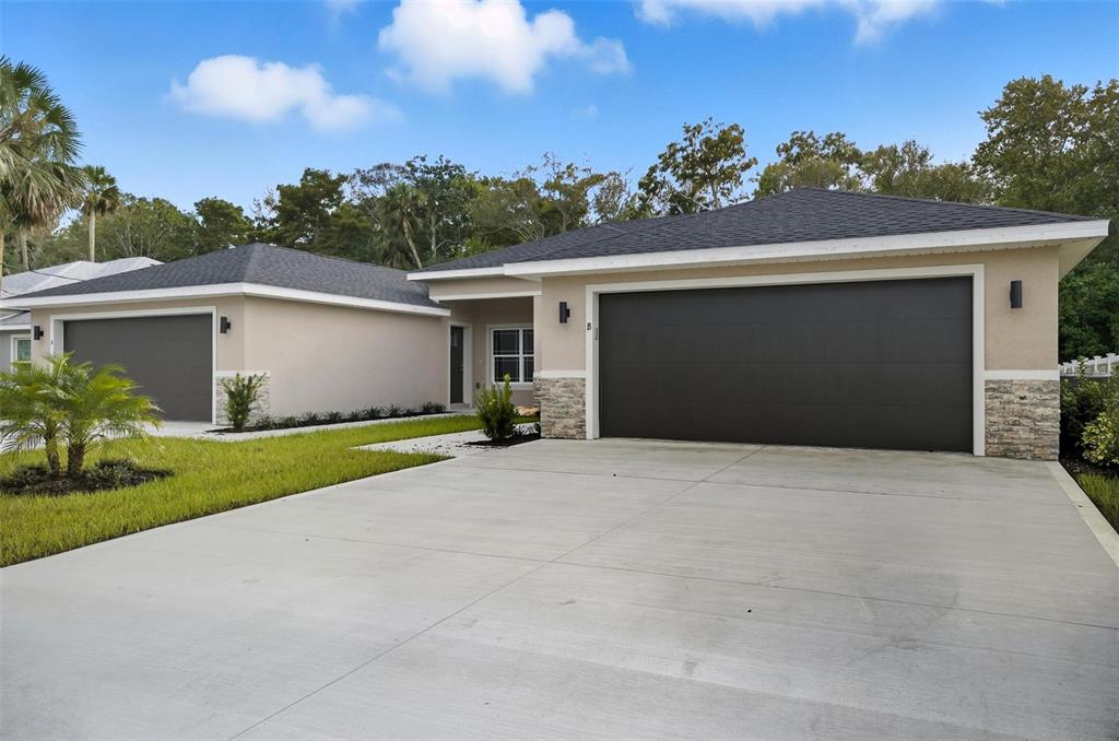 13 Fanshawe Lane Palm Coast, FL 32137 - Photo 40 of 60 a front view of a house with a garage