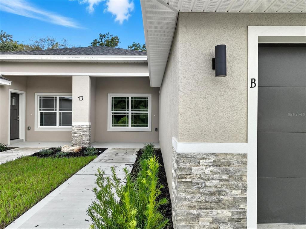 13 Fanshawe Lane Palm Coast, FL 32137 - Photo 52 of 60 a front view of a house with a yard