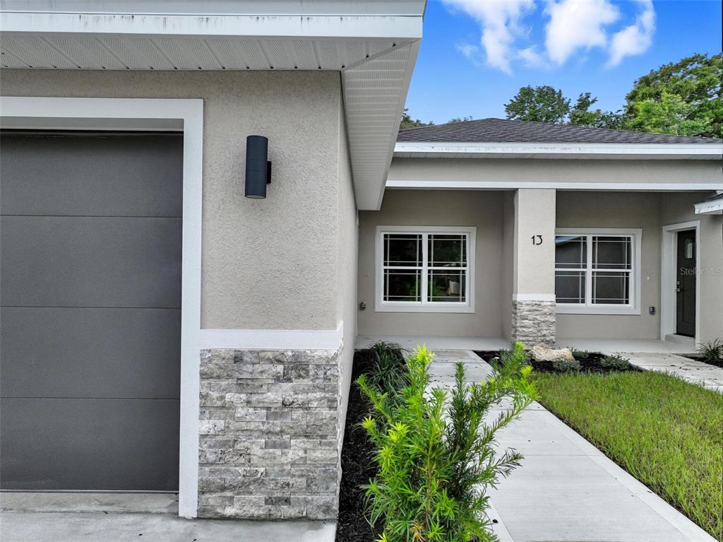13 Fanshawe Lane Palm Coast, FL 32137 - Photo 53 of 60 a front view of a house with a garden