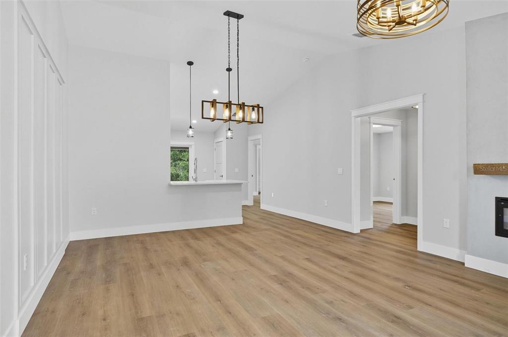 13 Fanshawe Lane Palm Coast, FL 32137 - Photo 6 of 60 an empty room with wooden floor cabinet and windows