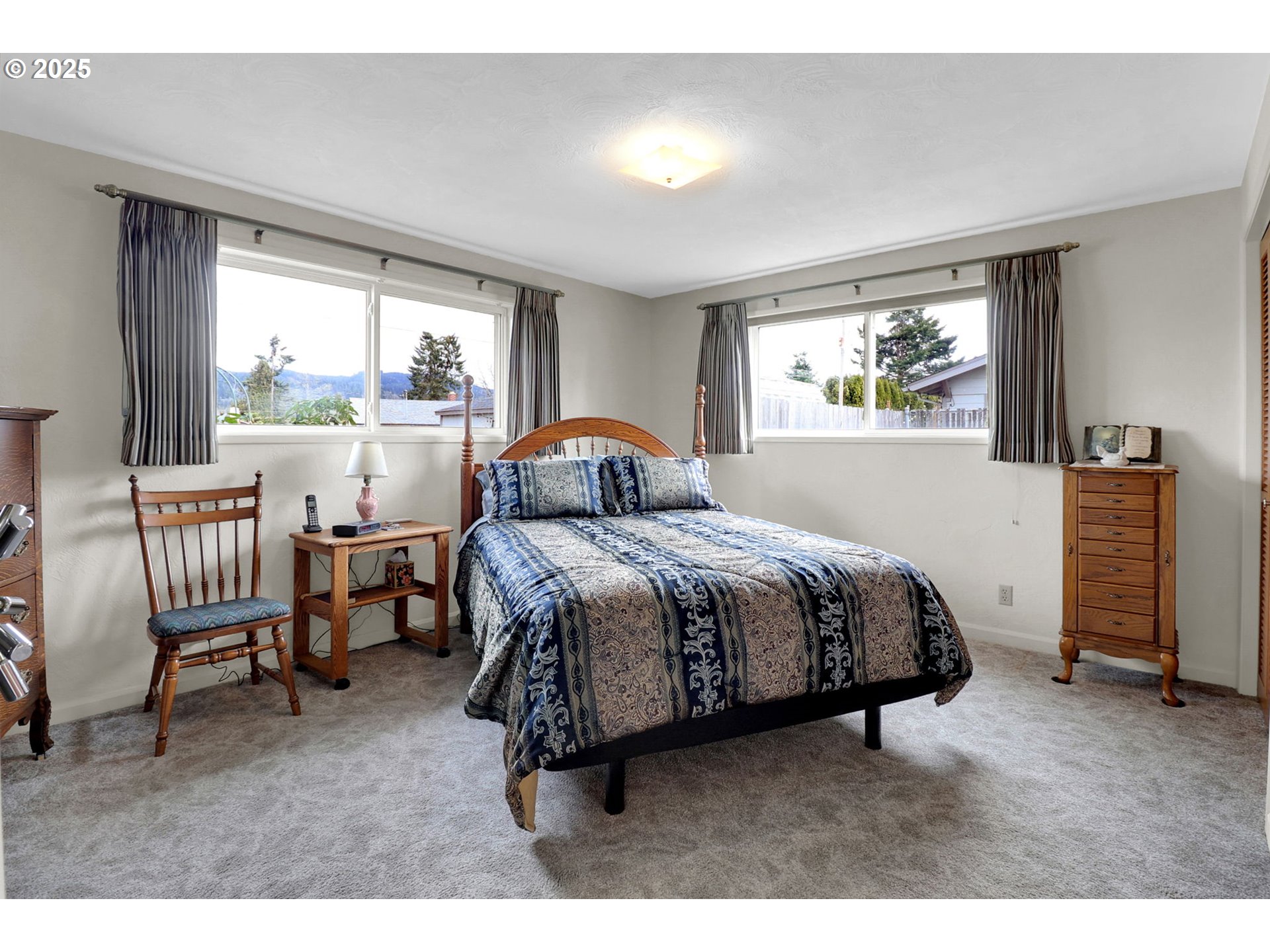 1448 Cheek Street Springfield, OR 97477 - Photo 18 of 28 a spacious bedroom with a bed a chair and large window