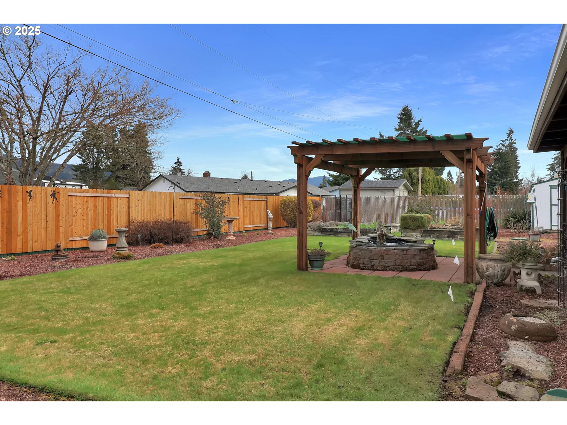 1448 Cheek Street Springfield, OR 97477 - Photo 25 of 28 a view of a patio with table and chairs under an umbrella