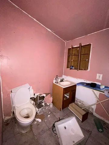 a living room with furniture large window and flat screen tv