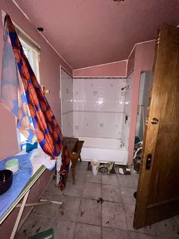 a living room with furniture a flat screen tv and a window