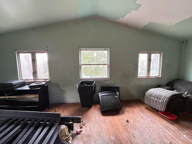 a bedroom with furniture and wooden floor