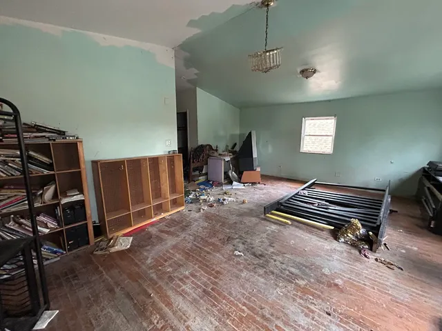 a bed room with furniture and a potted plant
