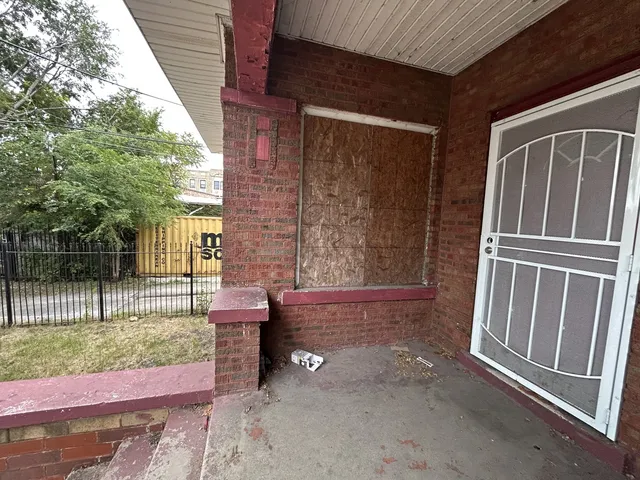 a living room with patio furniture and a floor to ceiling window