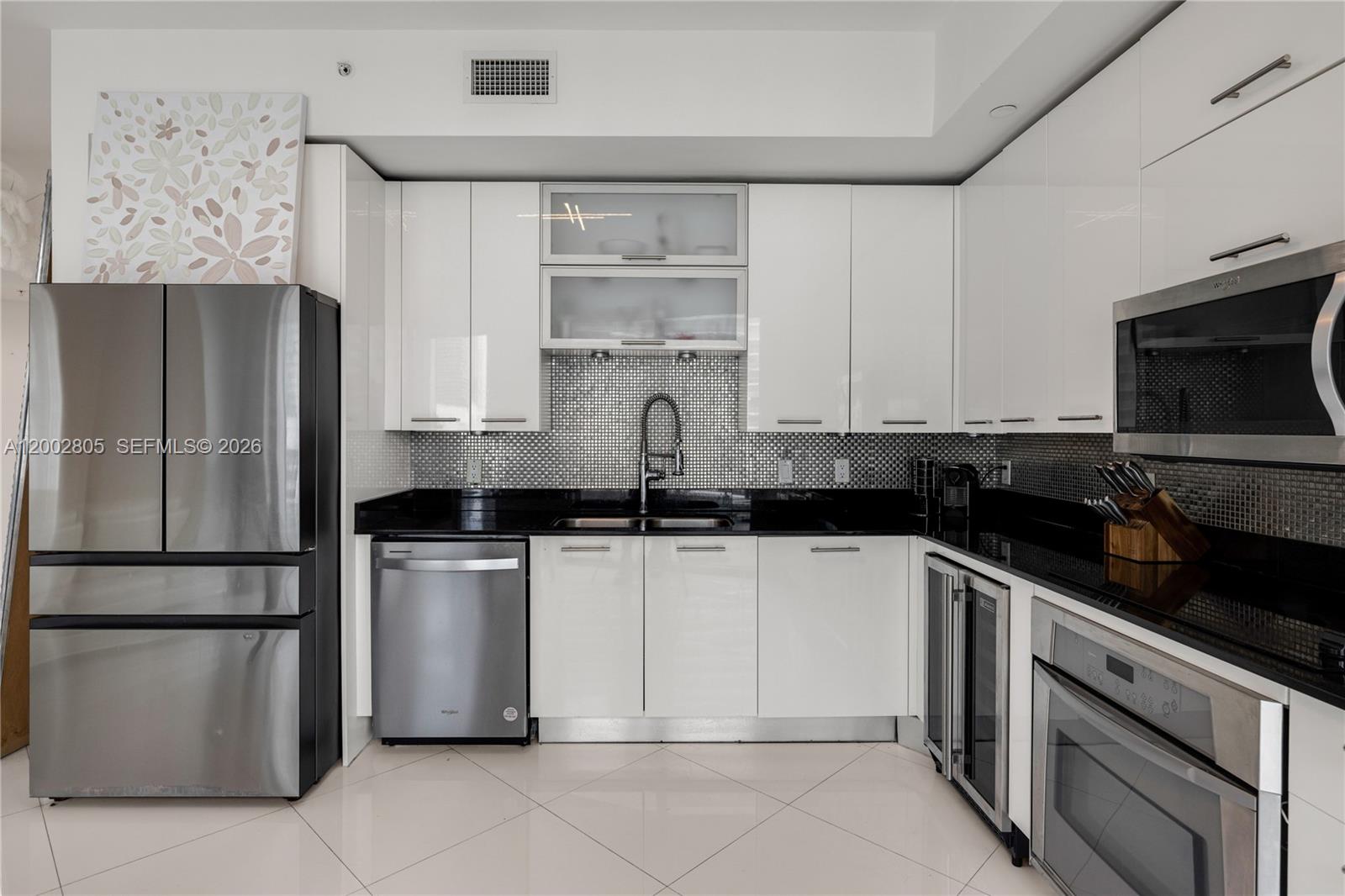 60 Southwest 13th Street, Unit 1124 Miami, FL 33130 - Photo 7 of 30 a kitchen with stainless steel appliances granite countertop a refrigerator and a stove top oven