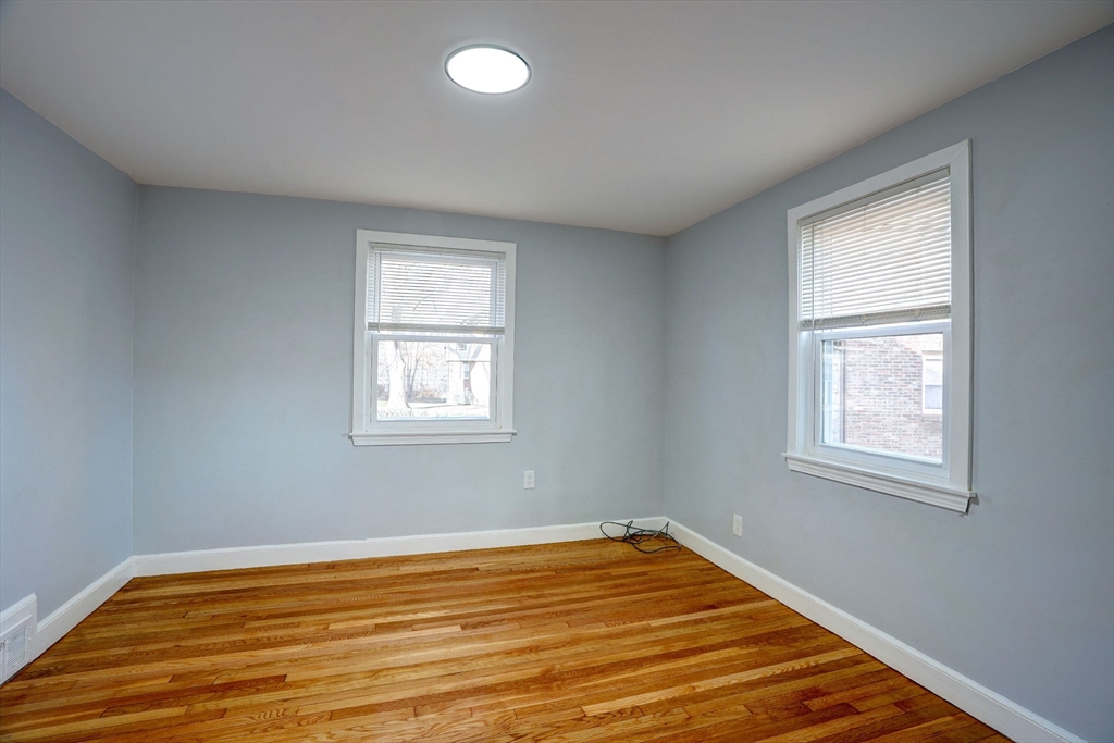 23 Langley Circle, Unit 1 Quincy, MA 02170 - Photo 17 of 27 a view of a room with wooden floor and windows