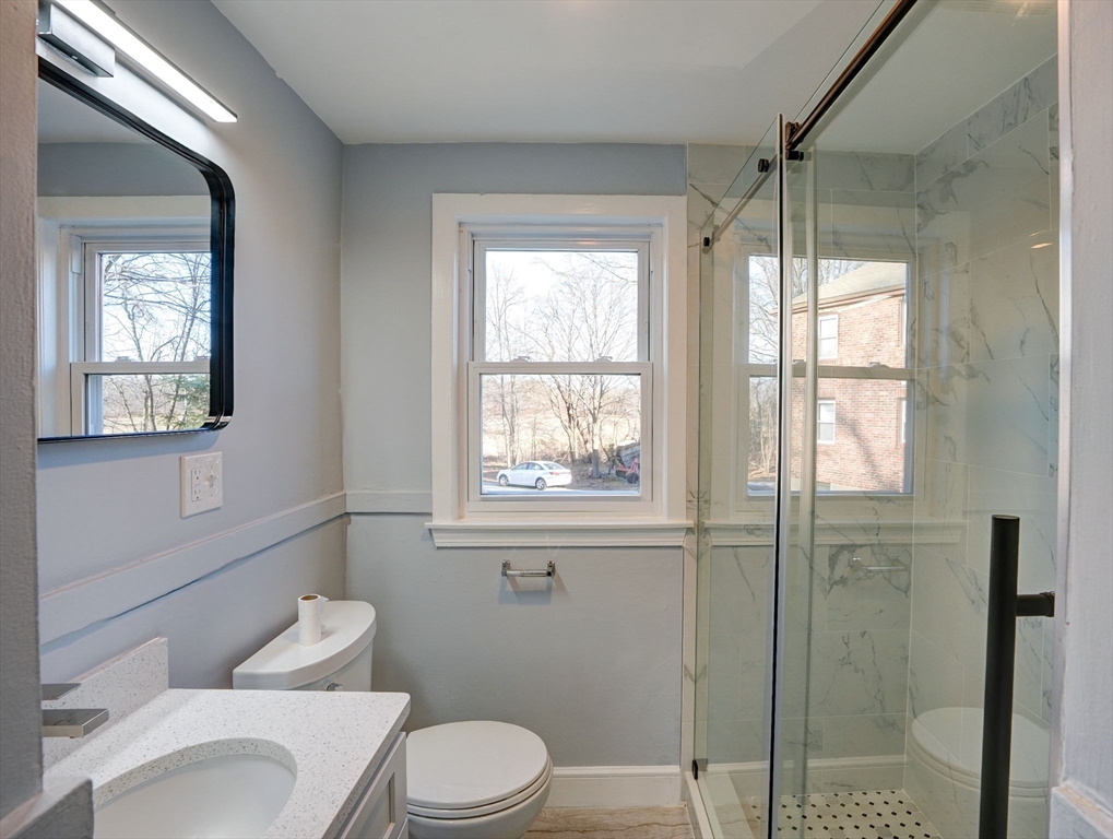 23 Langley Circle, Unit 1 Quincy, MA 02170 - Photo 18 of 27 a bathroom with a toilet a sink and a shower