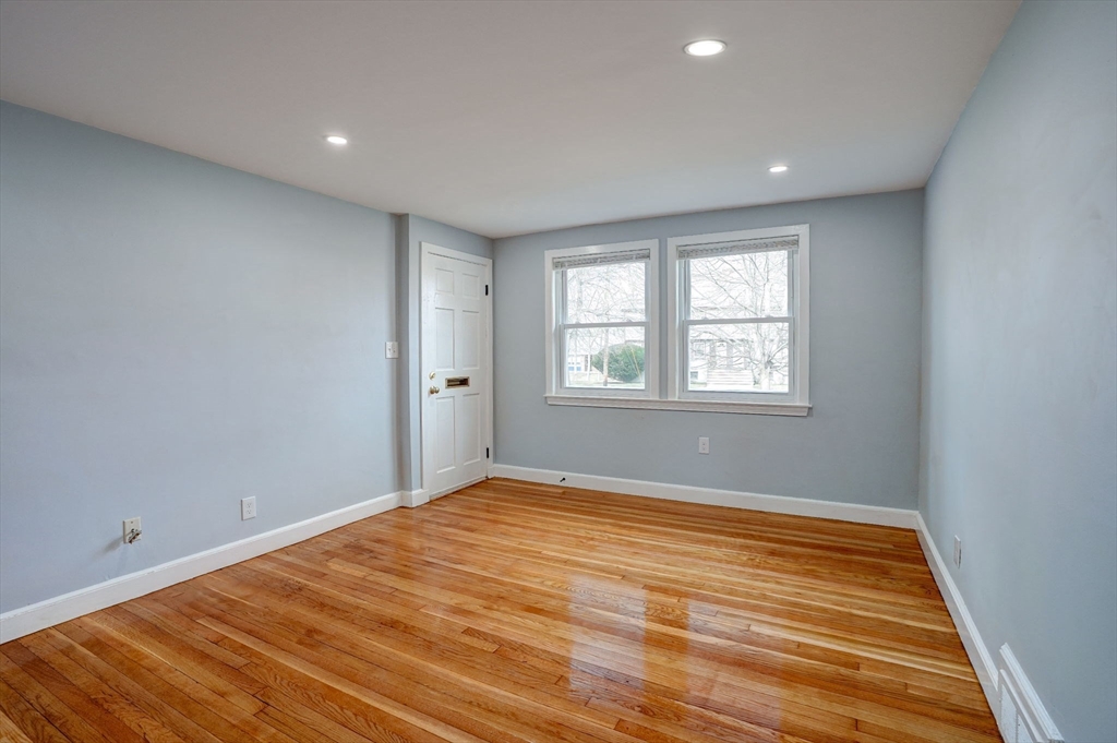 23 Langley Circle, Unit 1 Quincy, MA 02170 - Photo 5 of 27 a view of empty room with wooden floor and fan