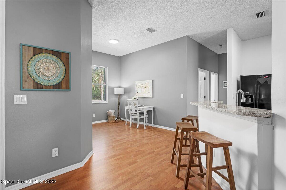 2030 Weber Road Malabar, FL 32950 - Photo 11 of 41 a view of a dining room with furniture and wooden floor