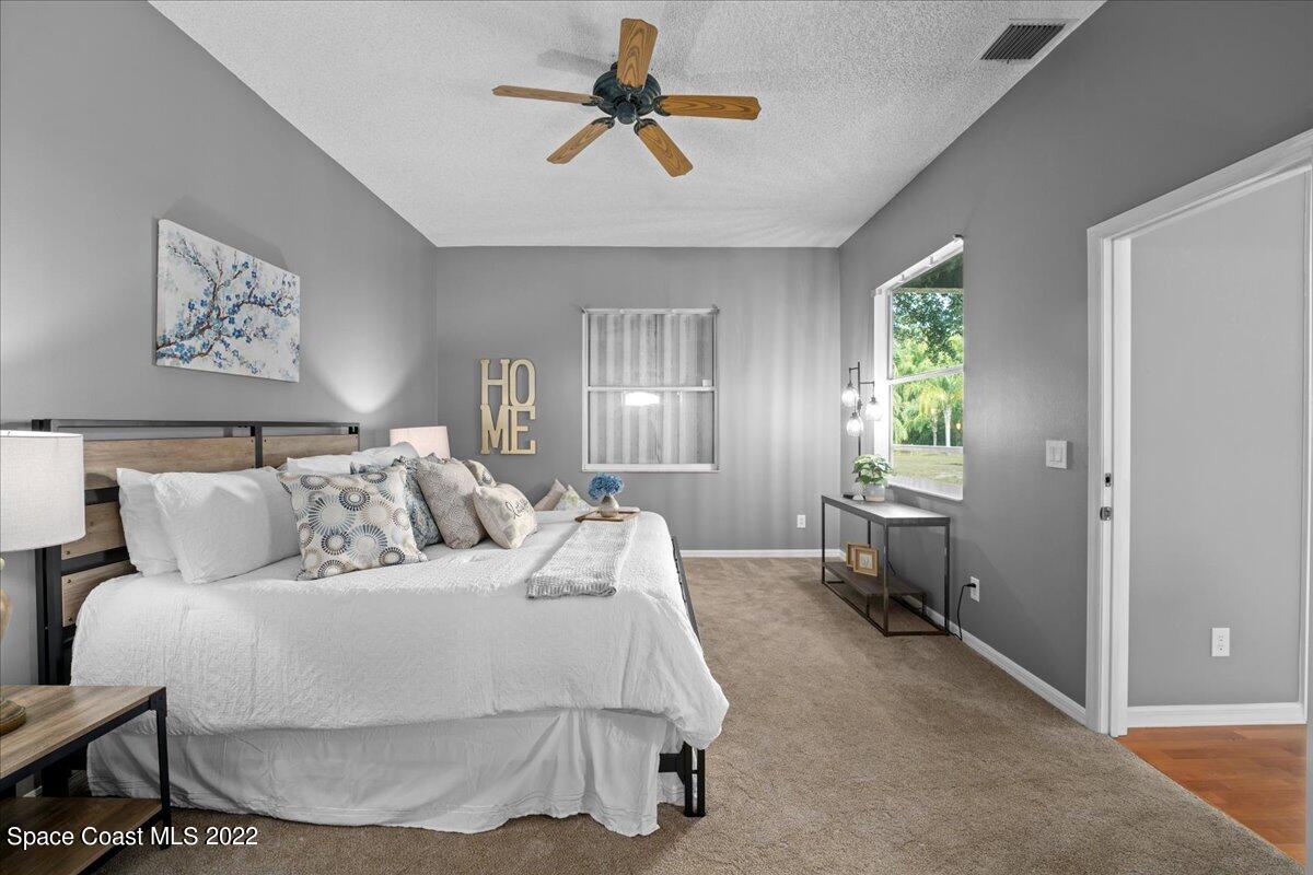 2030 Weber Road Malabar, FL 32950 - Photo 14 of 41 a bed room with a bed and a chandelier