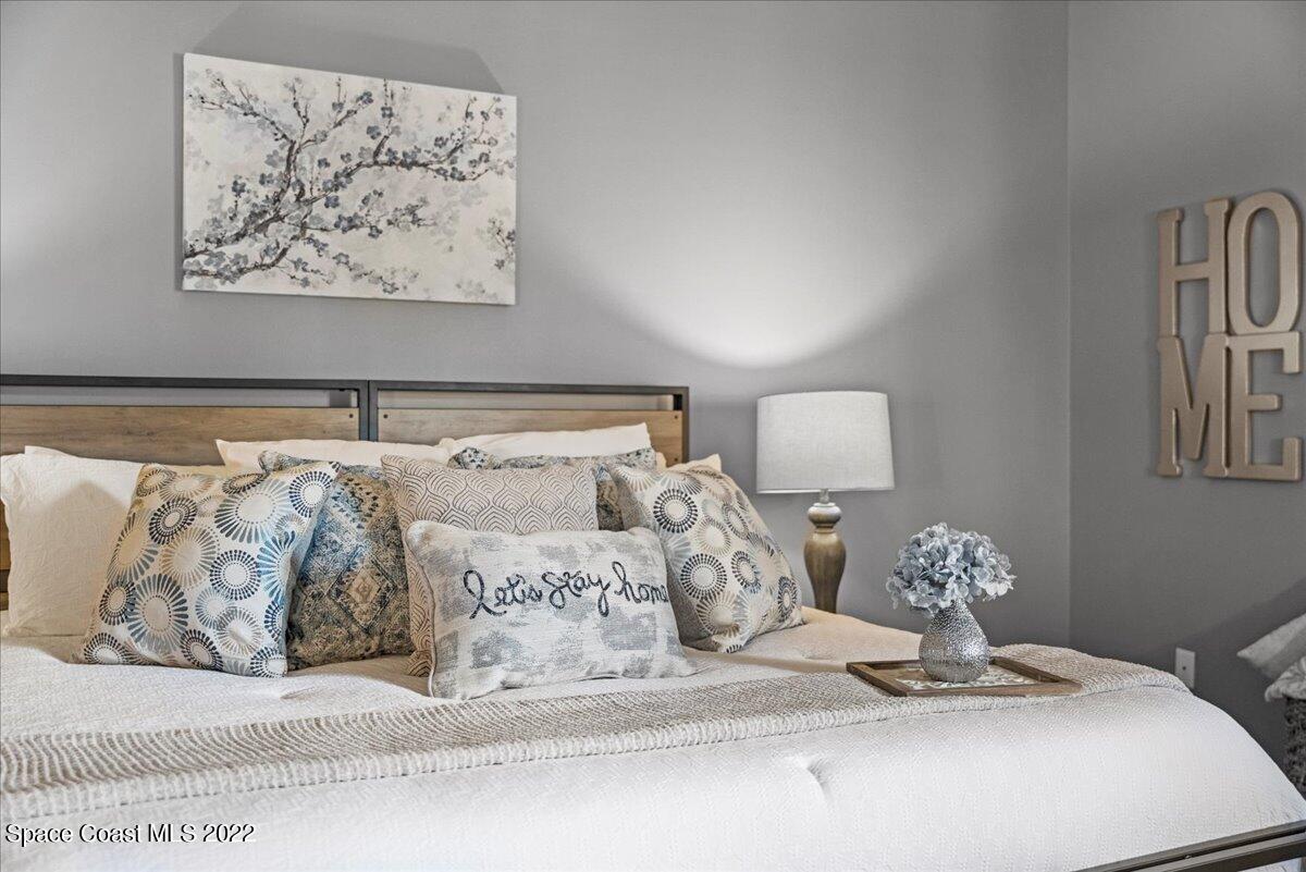2030 Weber Road Malabar, FL 32950 - Photo 15 of 41 a bedroom with a bed and a painting on the wall