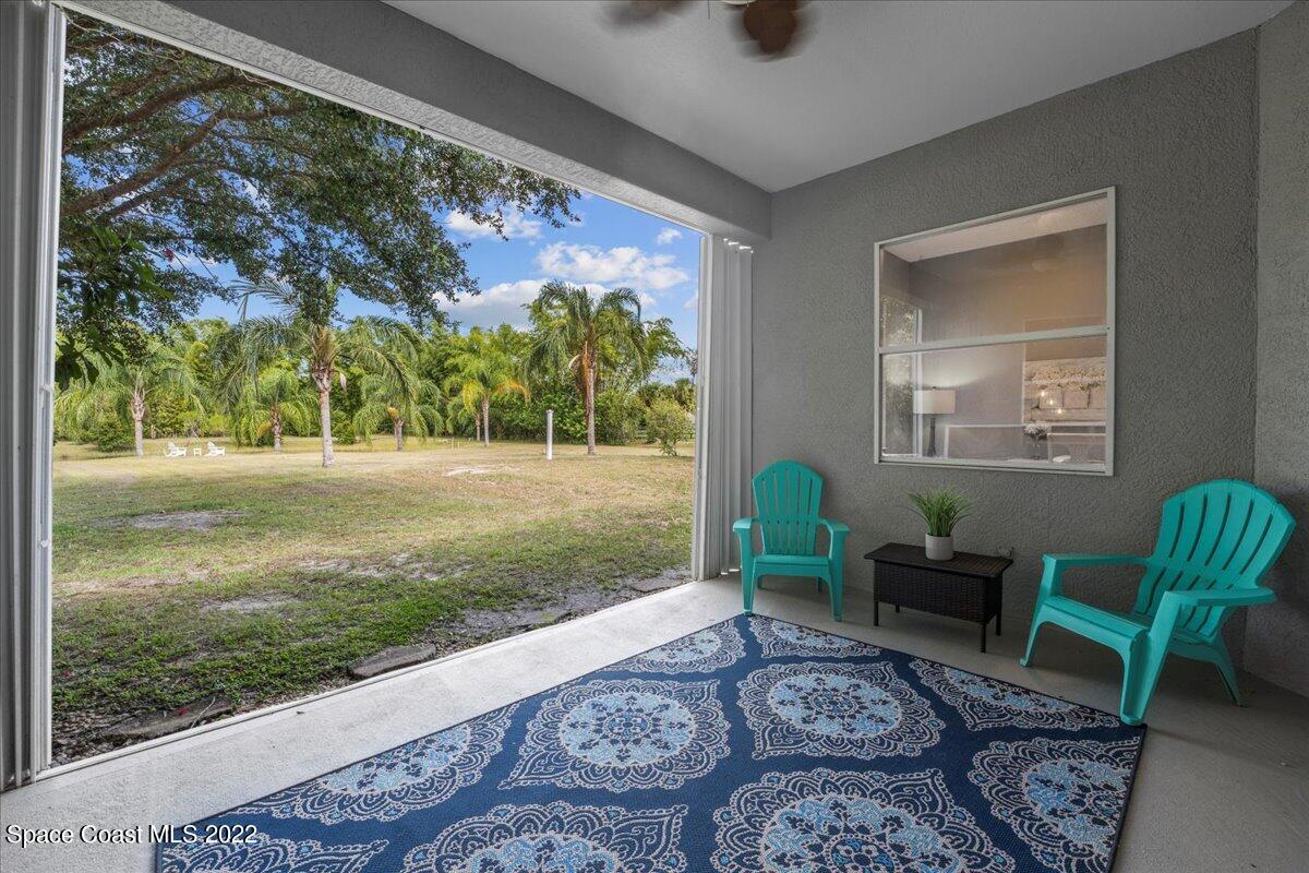 2030 Weber Road Malabar, FL 32950 - Photo 20 of 41 a living room with couch and a floor to ceiling window