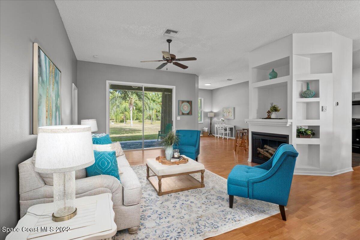 2030 Weber Road Malabar, FL 32950 - Photo 4 of 41 a living room with furniture a fireplace and a window