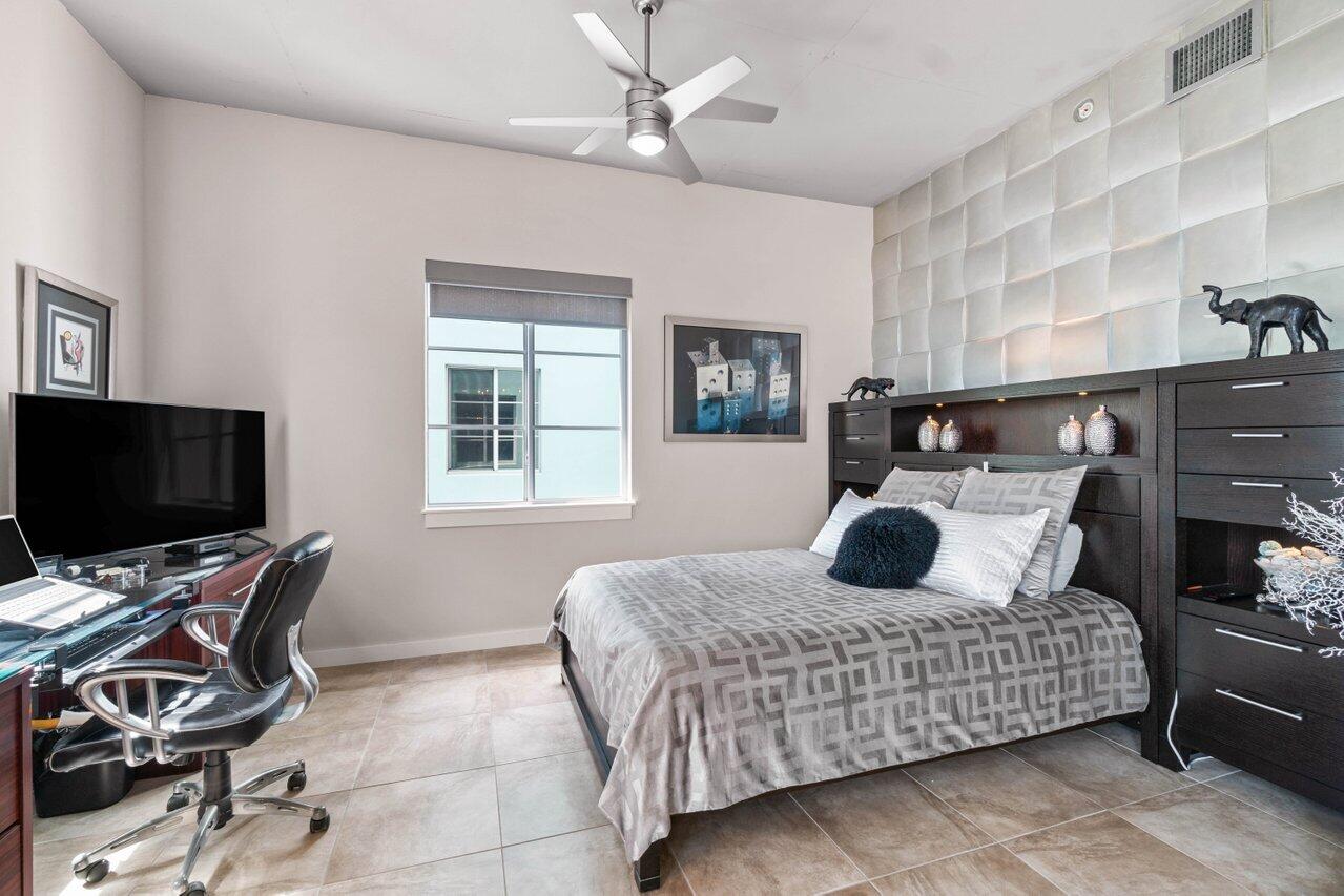 335 Southeast 6th Avenue, Unit 304 Delray Beach, FL 33483 - Photo 11 of 37 a bedroom with a bed and wooden floor