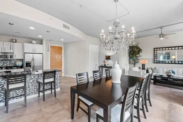 a view of a dining room with furniture and chandelier