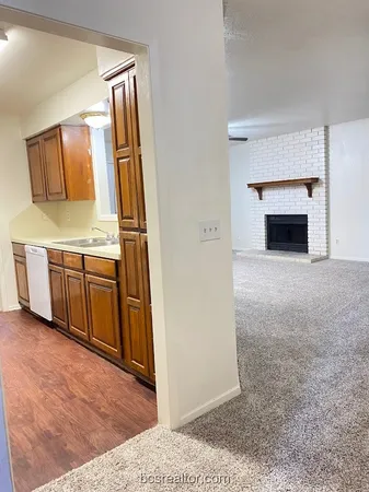 a view of a kitchen with a sink and a fireplace