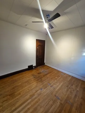 an empty room with wooden floor