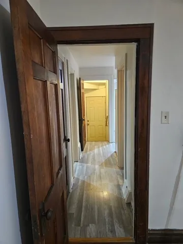 a view of a hallway with wooden floor