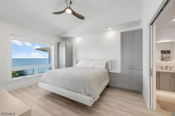 a large white bed in a white room