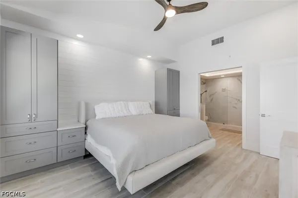 a bedroom with a bed and a view of living room