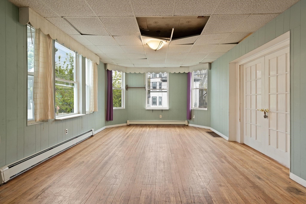 68 Murdock Street Boston, MA 02135 - Photo 11 of 35 a view of an empty room with a window and wooden floor