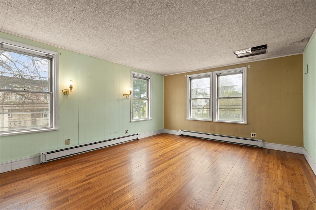 68 Murdock Street Boston, MA 02135 - Photo 22 of 35 an empty room with wooden floor and windows