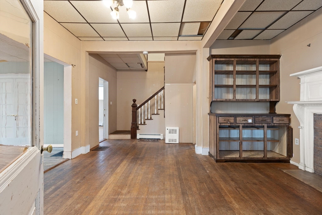 68 Murdock Street Boston, MA 02135 - Photo 8 of 35 a view of a livingroom with wooden floor and fireplace