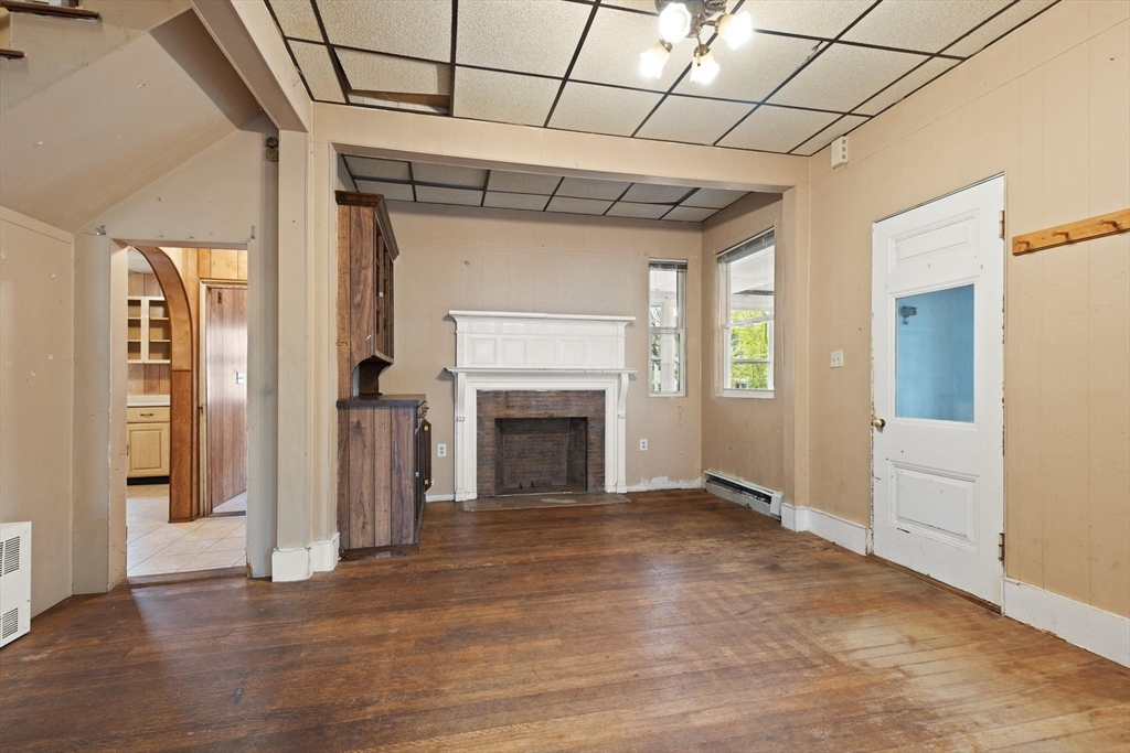 68 Murdock Street Boston, MA 02135 - Photo 9 of 35 a view of empty room with wooden floor and fireplace