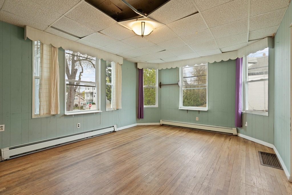 68 Murdock Street Boston, MA 02135 - Photo 10 of 35 an empty room with wooden floor and windows